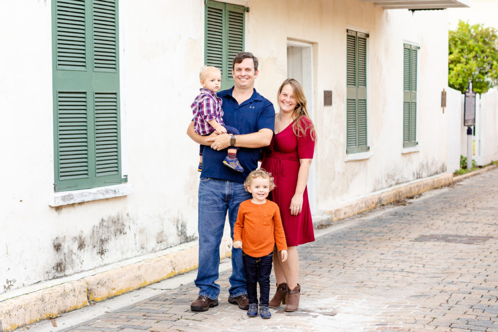 Family of four in St Augustine dressed for a family portrait session. What to wear for a family of four.