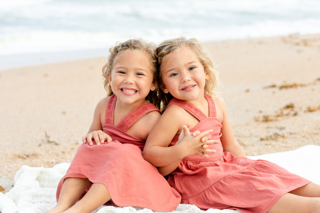 Twin little girls during a family portrait session. Genuine Smiles