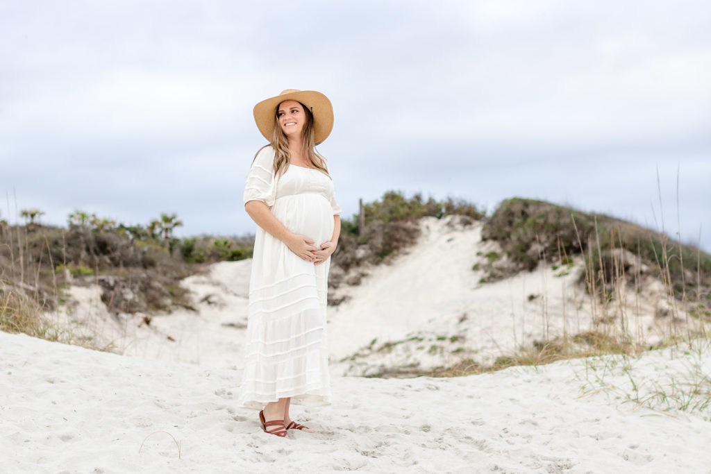 Pregnant woman at maternity session holding her baby bump