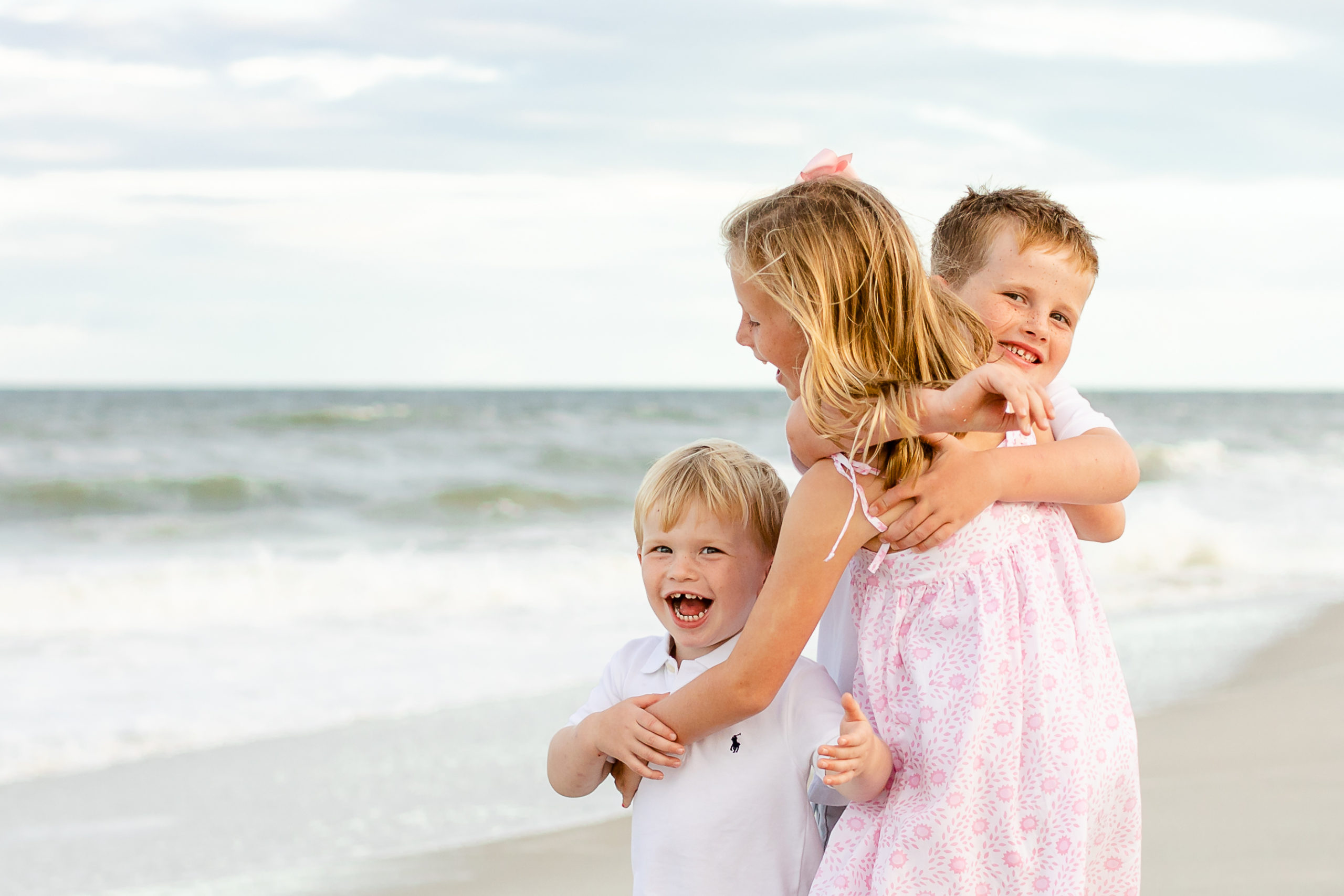 Siblings hugging each other at a family photography session
